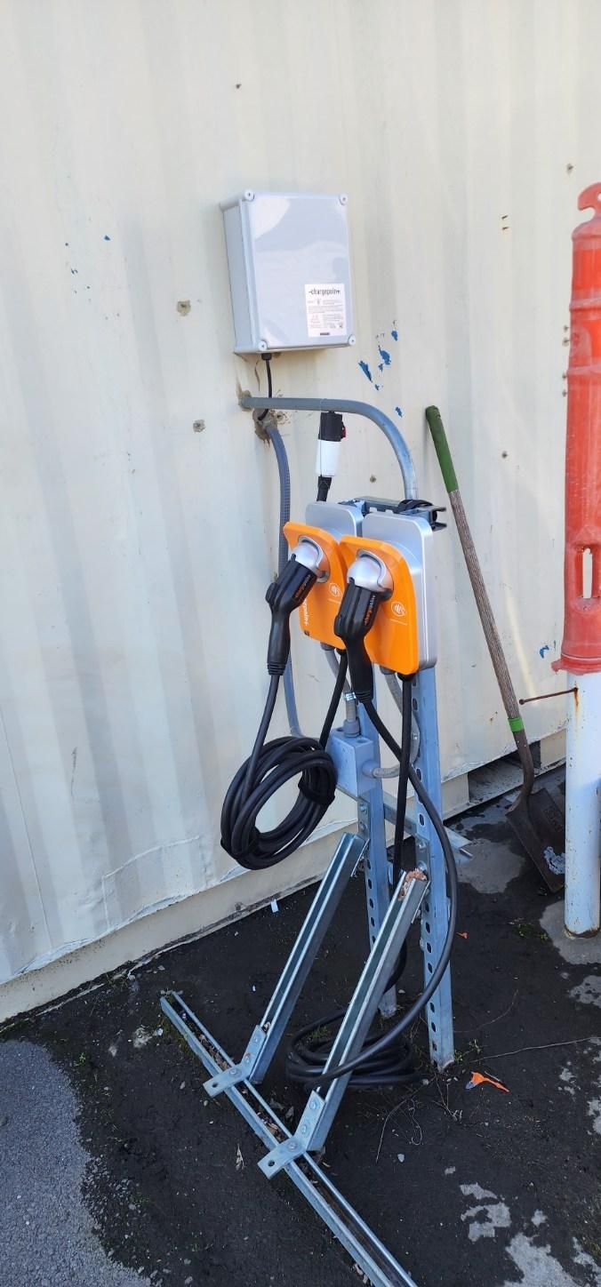 electric vehicle charger charging a yellow car